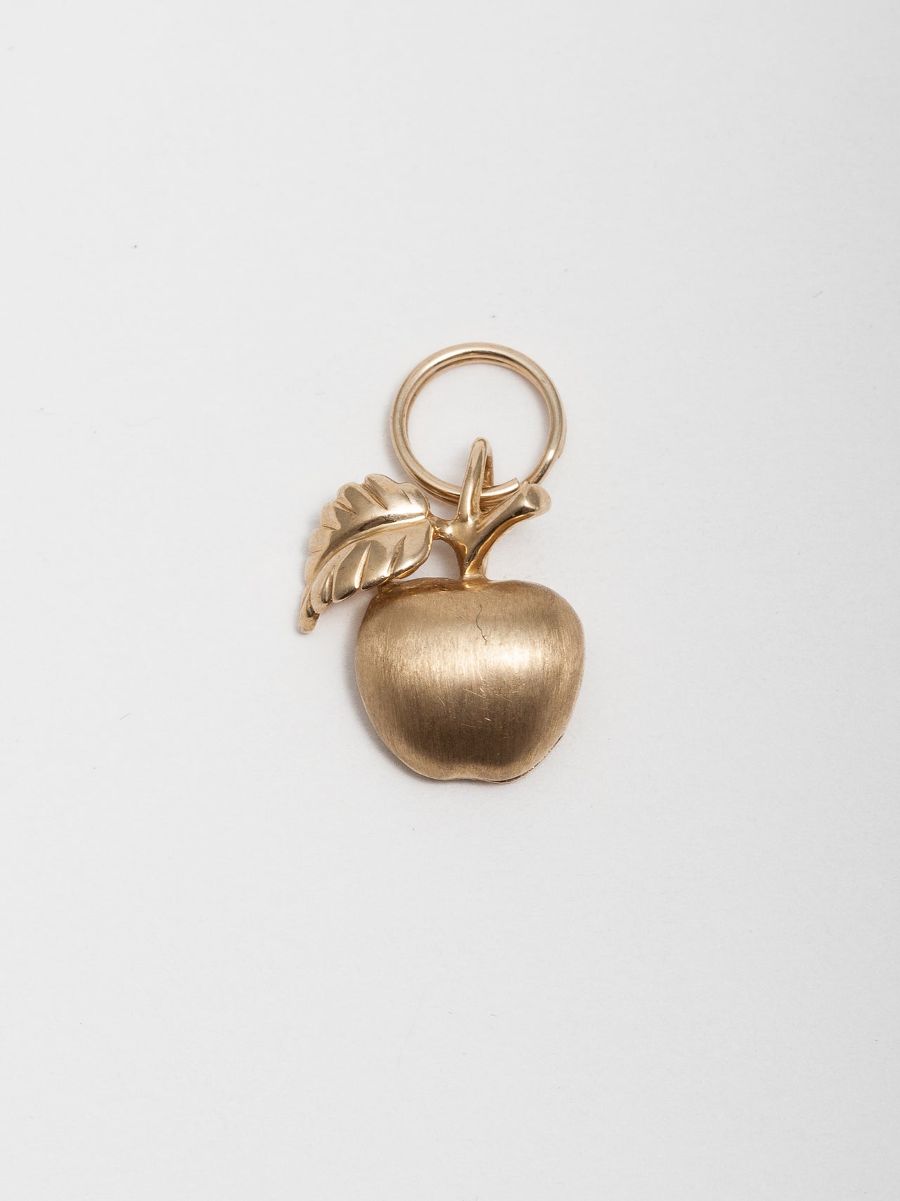 14Kt Yellow Gold Apple Charm pictured on light grey background. 