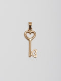 14Kt Yellow Gold Key Pendant pictured on light grey background. 