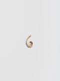 Birds eye view of 14kt Yellow Gold Ear Cuff pictured on light grey background.