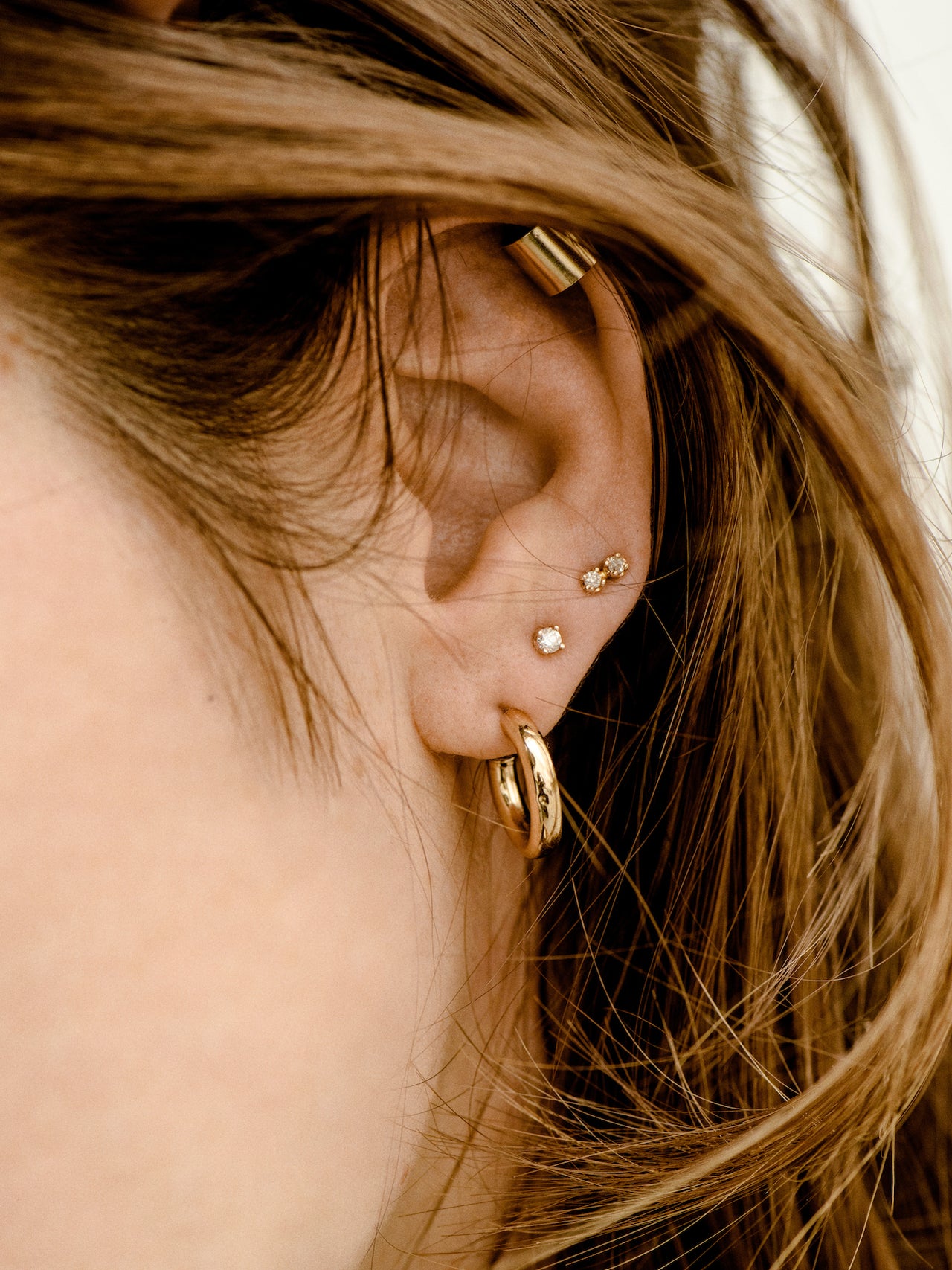 14kt Yellow Gold Ear Cuff pictured on models top ear lobe. 