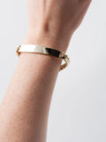 14kt Yellow Gold Solid XL Cuban Chain ID Bracelet pictured on models wrist. hand facing up. 