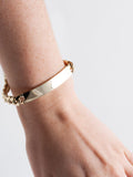 14kt Yellow Gold Solid XL Cuban Chain ID Bracelet pictured on models wrist. 