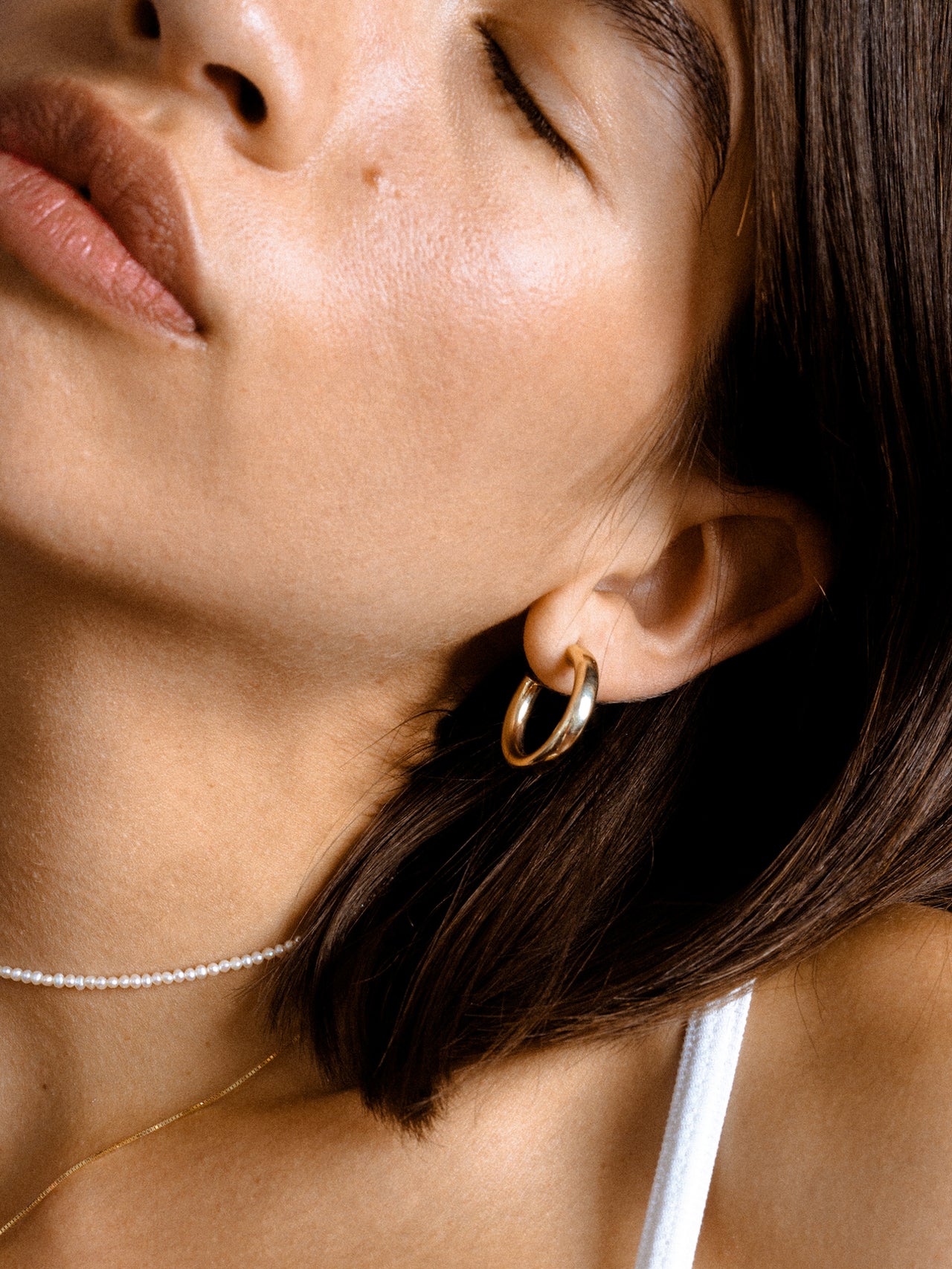 14Kt Yellow Gold Hoop Earrings pictured on model. 
