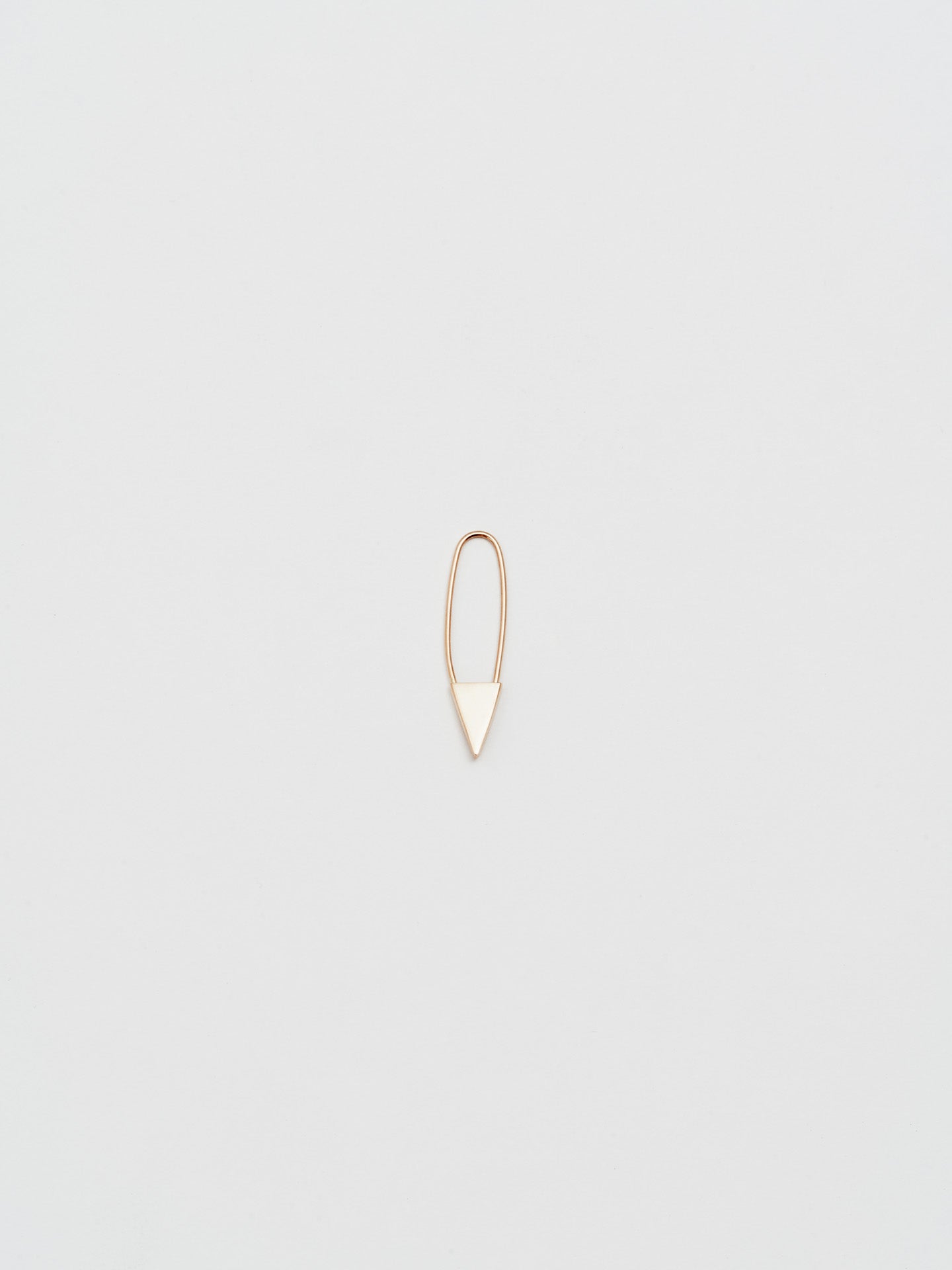 Mini Triangle Safety Pin Earring in Rose Gold, light grey background.