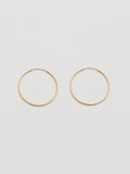 Product shot the Winona Hoops ( 14Kt Yellow Shiny Gold Hoops) Background: Grey paper 