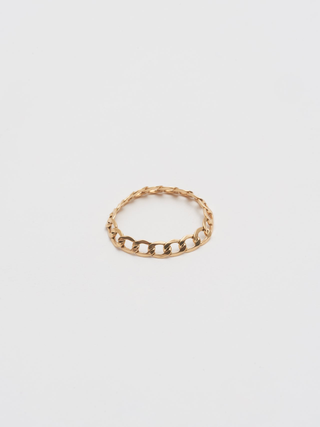 Product Shot of Havana Chain Ring (14kt Shiny Yellow Gold Hollow Flat Curb Chain with a width of 3.3mm) against white background