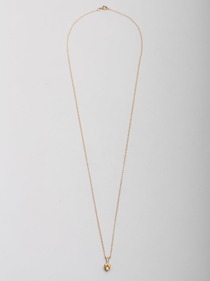 10Kt Yellow Gold Heart Necklace with Yellow CZ pictured on light grey background.