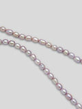 Close up of lavender pearls on necklace