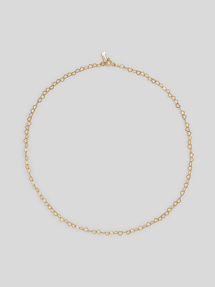 Product image of 10kt yellow gold heart linked chain necklace shot on white background. 