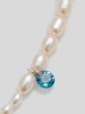 Satellite Pearl Earrings up close picture of blue london topaz gemstone and pearl. 