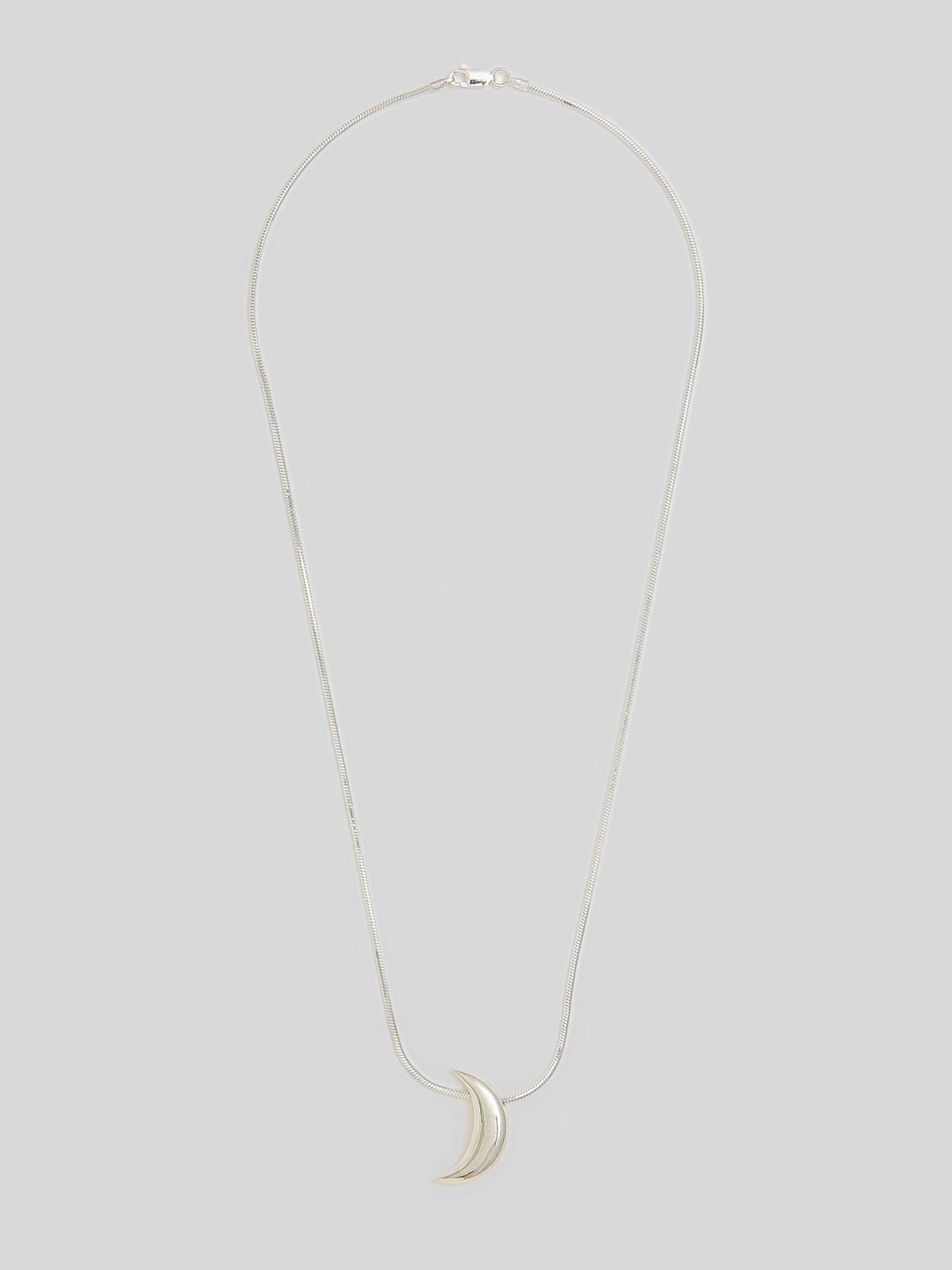 Product image of sterling silver snake chain necklacw with Silver Crescent moon pendant on white background. 