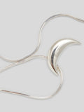 Close up of pendant on Product image of sterling silver snake chain necklacw with Silver Crescent moon pendant on white background. 