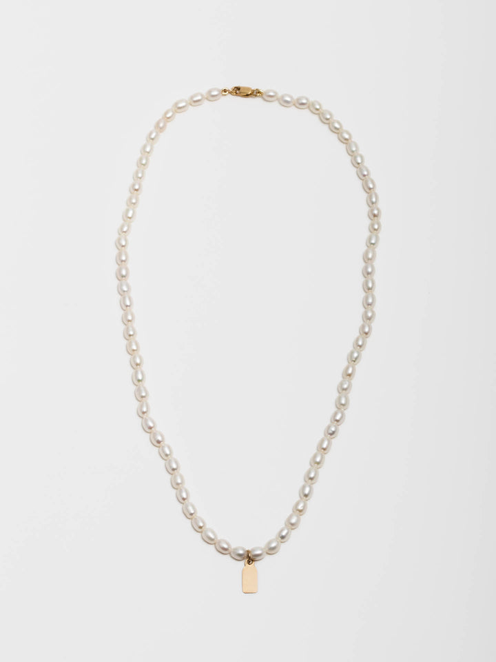 14kt Yellow Gold Pearl Id Charm Necklace pictured on white background.
