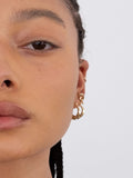 14kt Yellow Gold Amore Hammock Hoops pictured on models ear. 