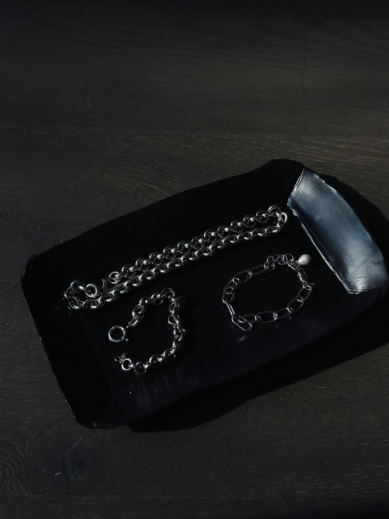 Euclid Necklace styled in flat lay with bracelets