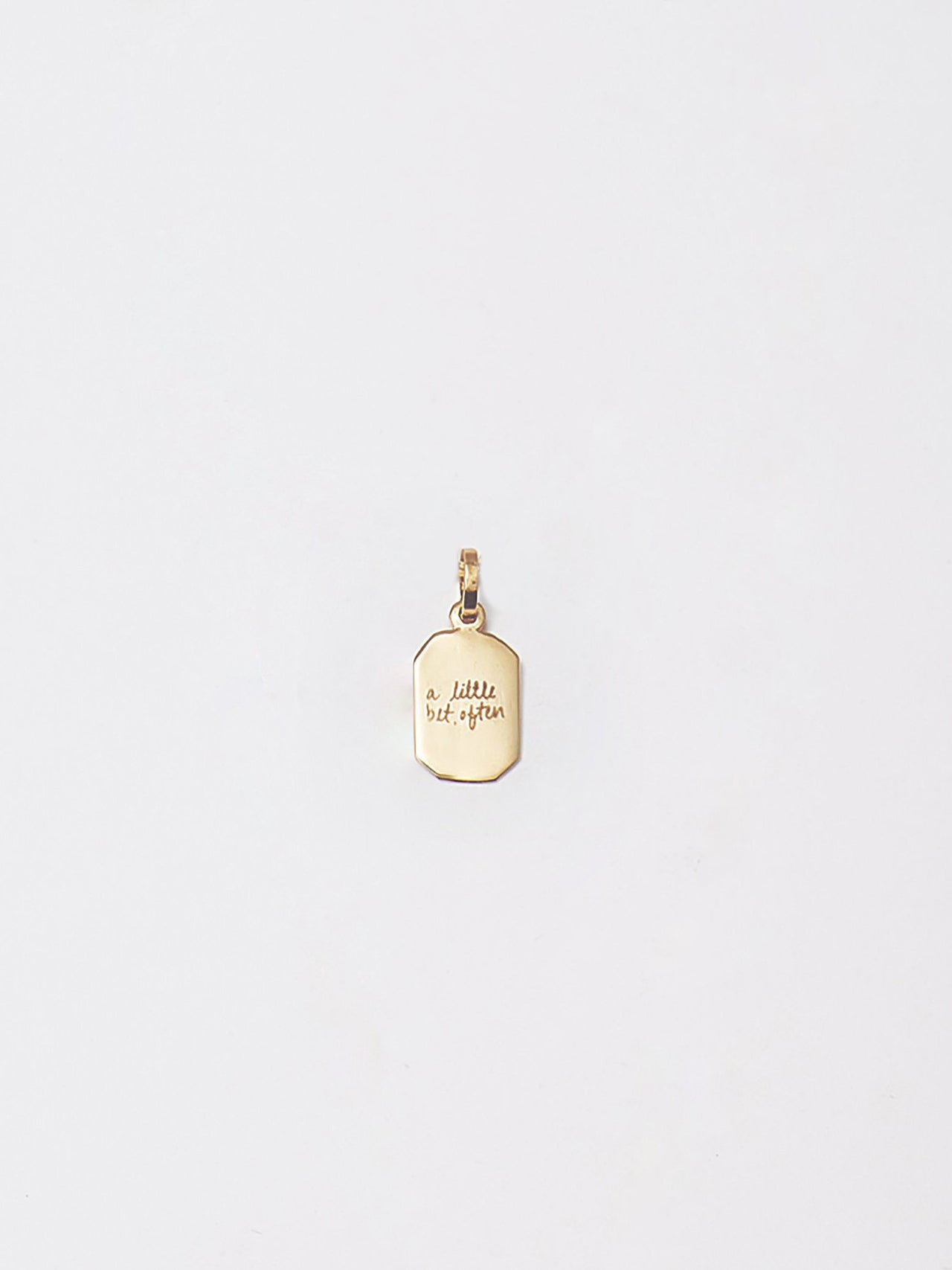 10kt yellow gold octagonal ID pendant with an engraving of: "a little bit often"