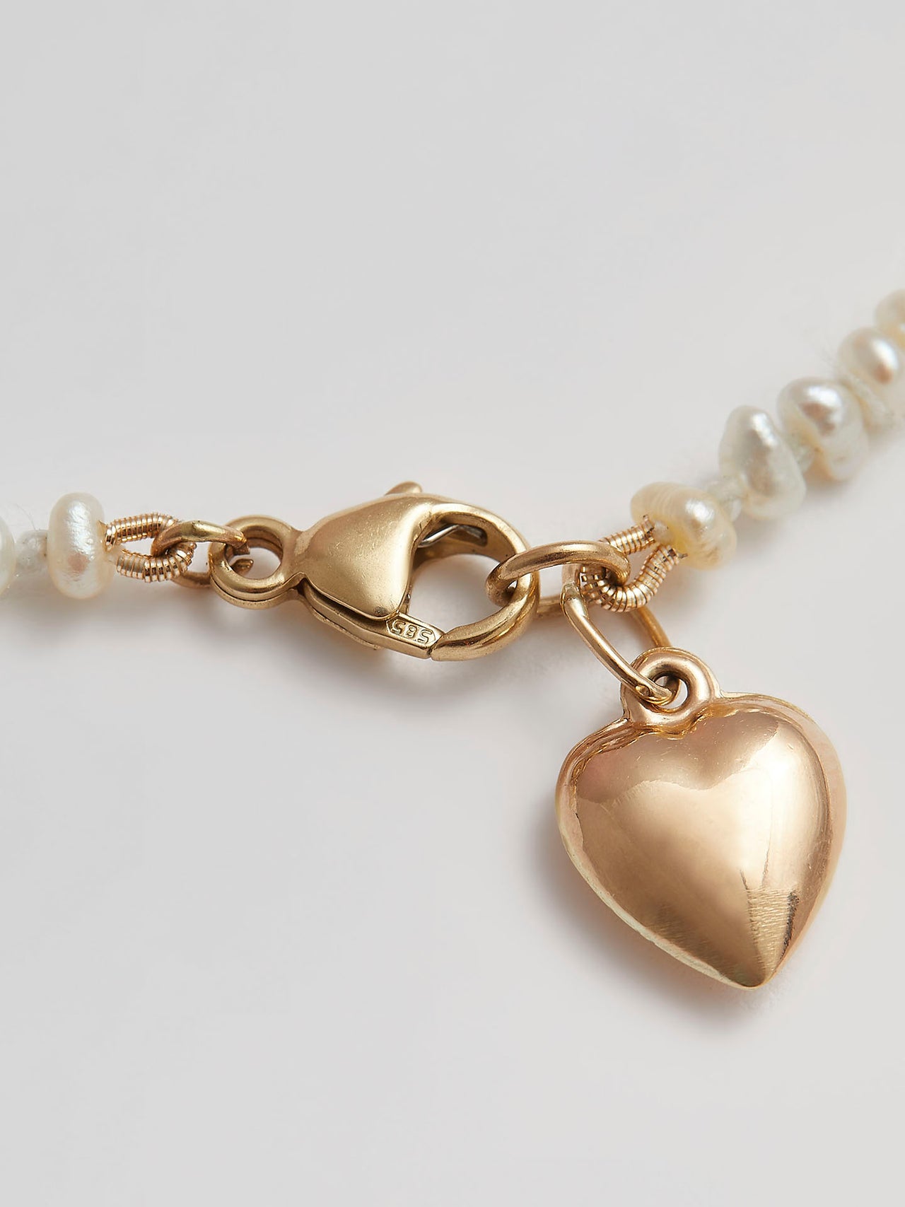 Close up of Clasp and Gold Heart Pendant on Puff Love Choker