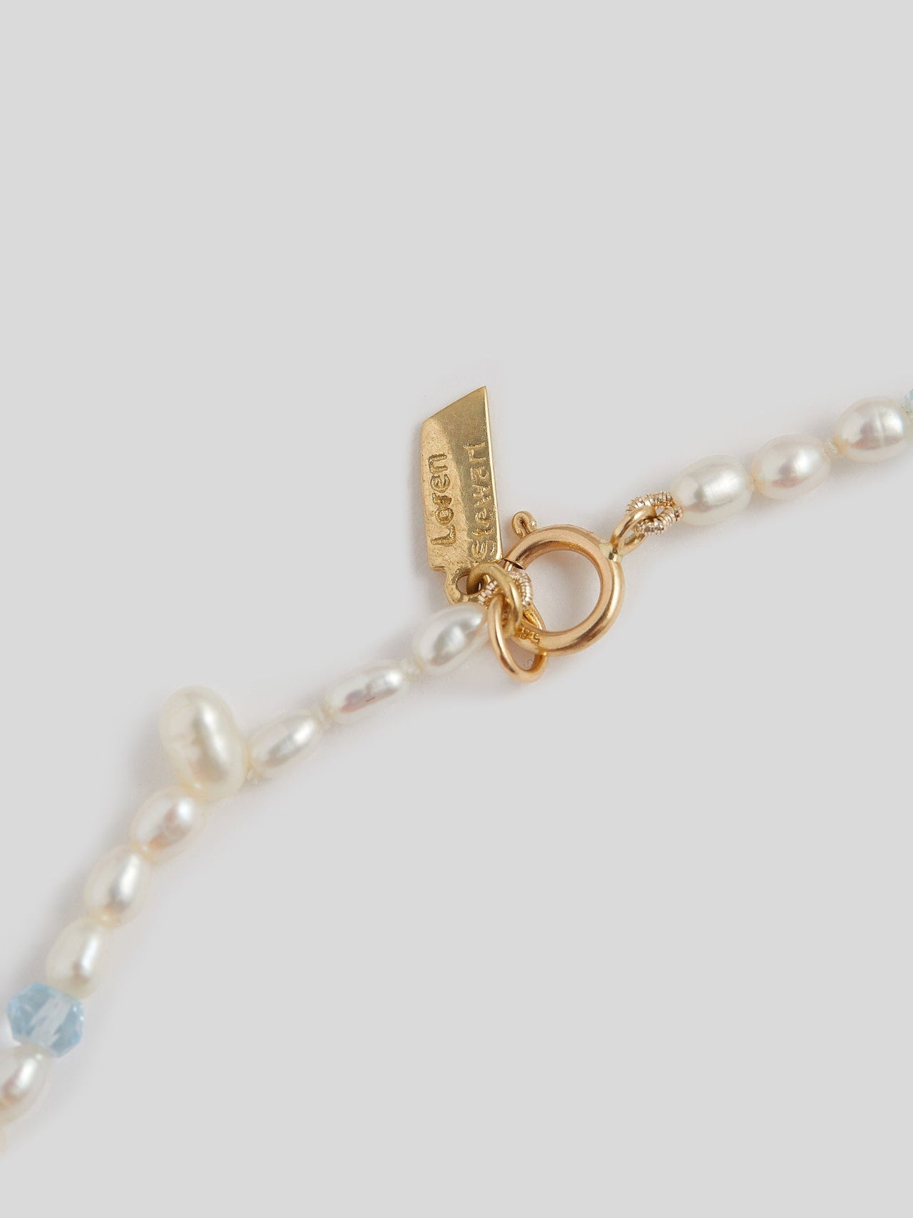  Assorted Freshwater Pearls & Gemstone Necklace close up of 14kt yellow gold closure and logo. 
