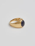 Side angle product shot of the Classico Iolite Signet (Vermeil Iolite Signet Ring Face: 12.9×2.8mm 8×11 Cabochon Iolite) Background: Grey backdrop