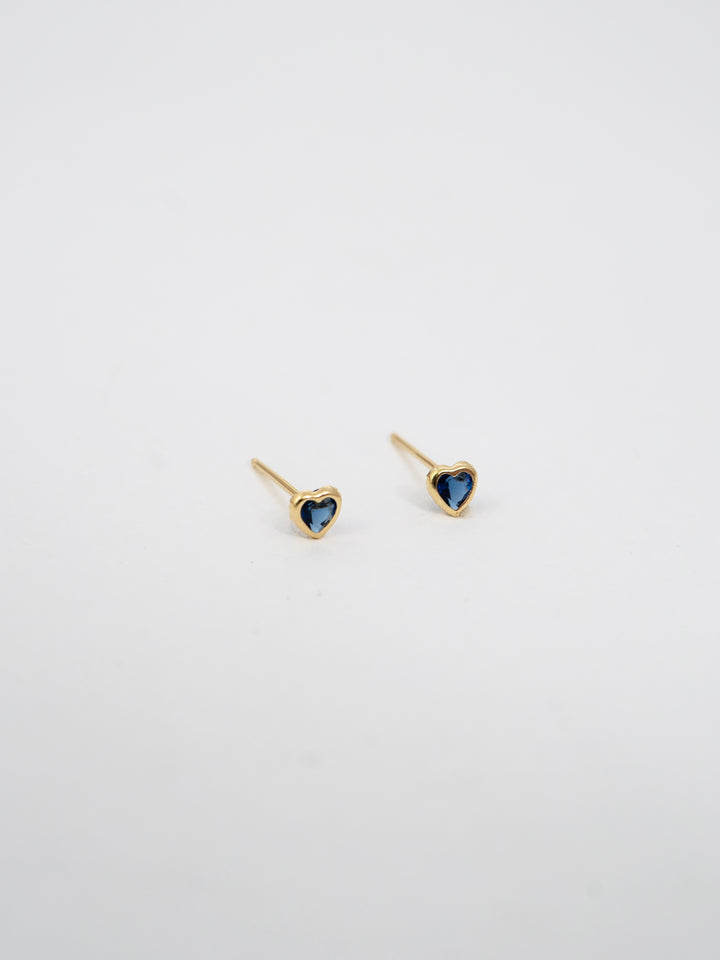 14kt Yellow Gold Heart Gemstone Studs pictured on light grey background.