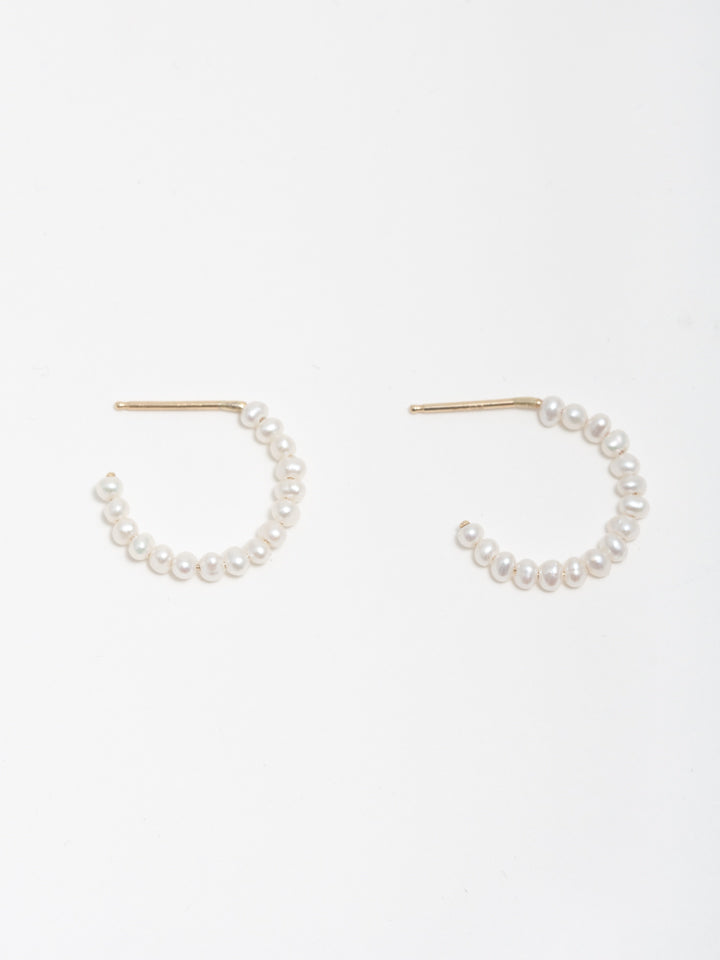 Product shot of pearl hoop earrings on white background