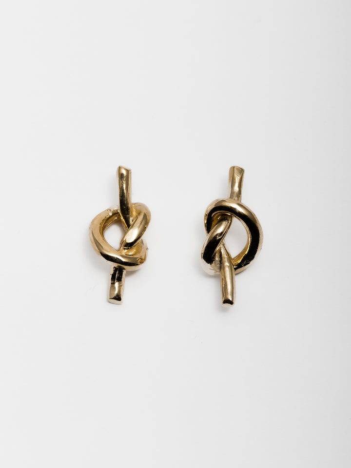 14kt Yellow Gold Knot Studs on White Background.