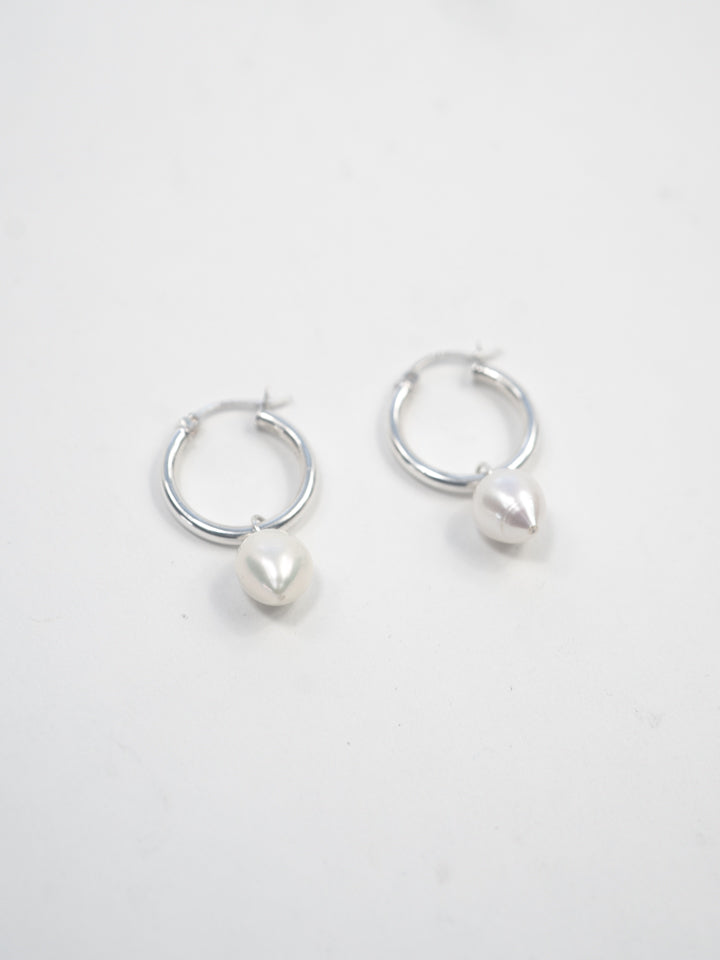 Product image of sterling silver hoops with pearl pendants on white background