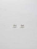 Product image of pearl stud earrings on white background