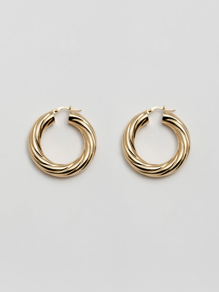 Product Shot of Whirlwind Hoops (14Kt Yellow Gold Hoop Earrings Diameter: 30mm Thickness: 6mm) Shoot on white background