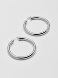 Side angle product shot of the Tru Hoops in Sterling Silver (Sterling Silver Hoops 49.5mm diameter  5mm thick) Background: Grey backdrop