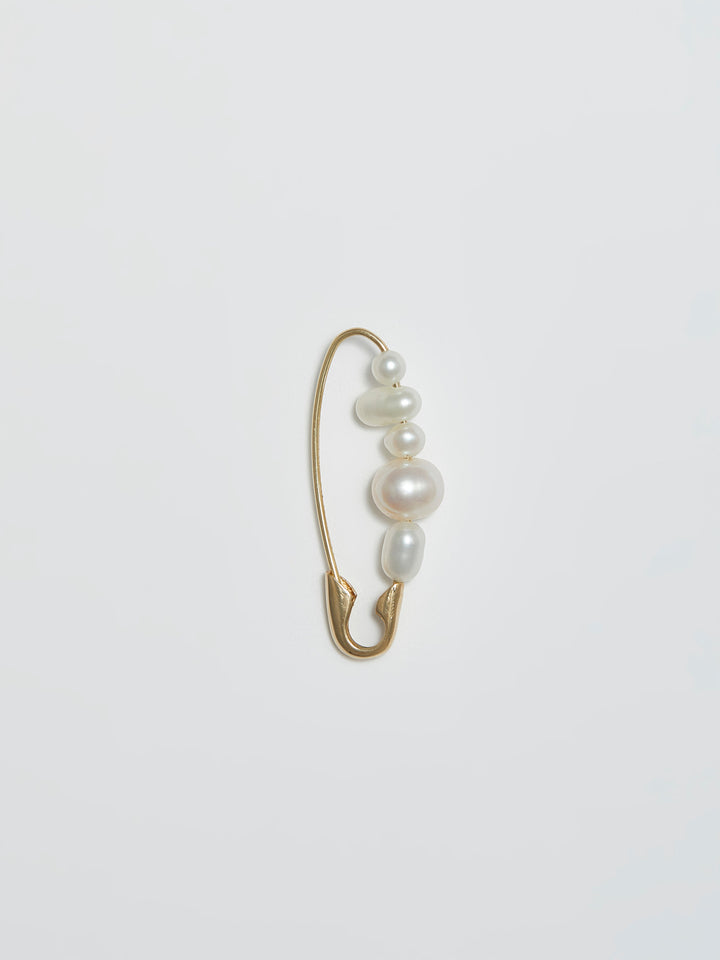 Product shot of the Mixed Pearl Safety Pin (14kt Yellow Gold Safety Pin 27mm Total Length Mixed Freshwater Pearls) Background: Grey backdrop