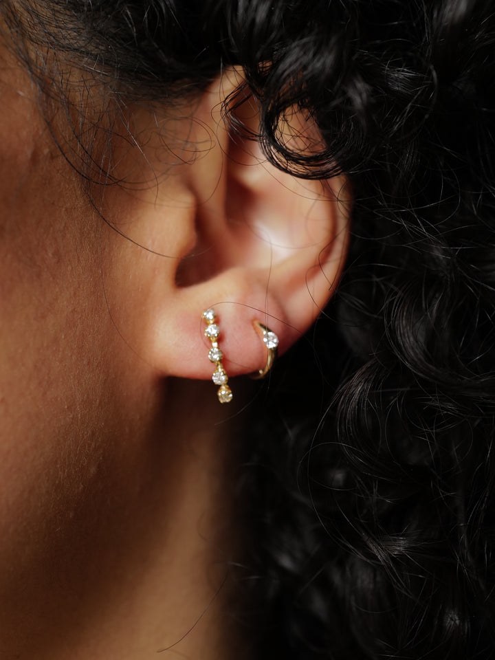 14Kt Yellow Gold Five Diamond Stud Earring pictured on models ear along with our Solo Sparkle Huggie. 
