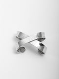 Sterling Silver X Cuff Bracelet pictured from above on light grey background.