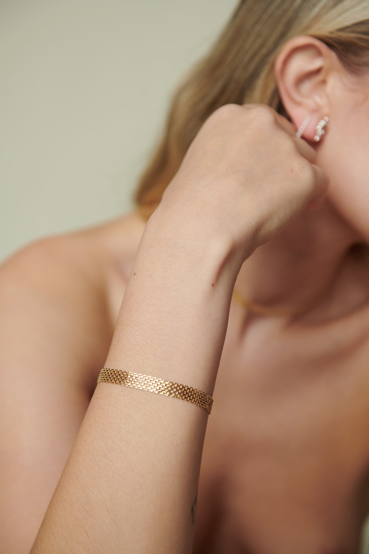 Vermeil Bizmark Chain Bracelet pictured on models wrist. Light beige background.